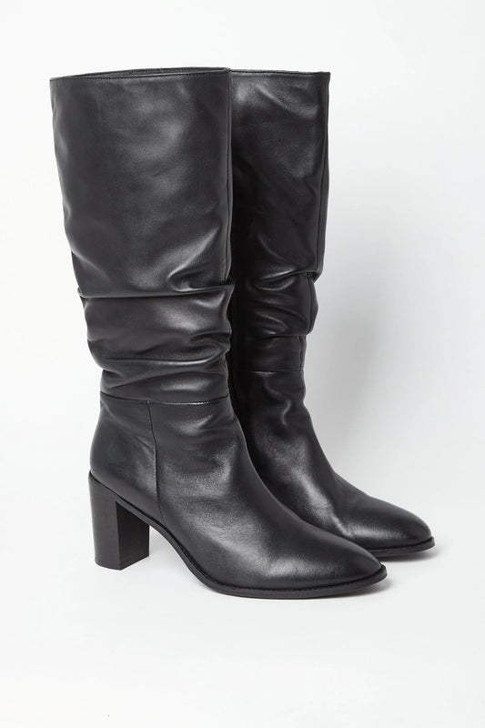 Edit No9. A pair of black leather ruched knee boots with a round-toed silhouette and a high block heel. Large sizes.