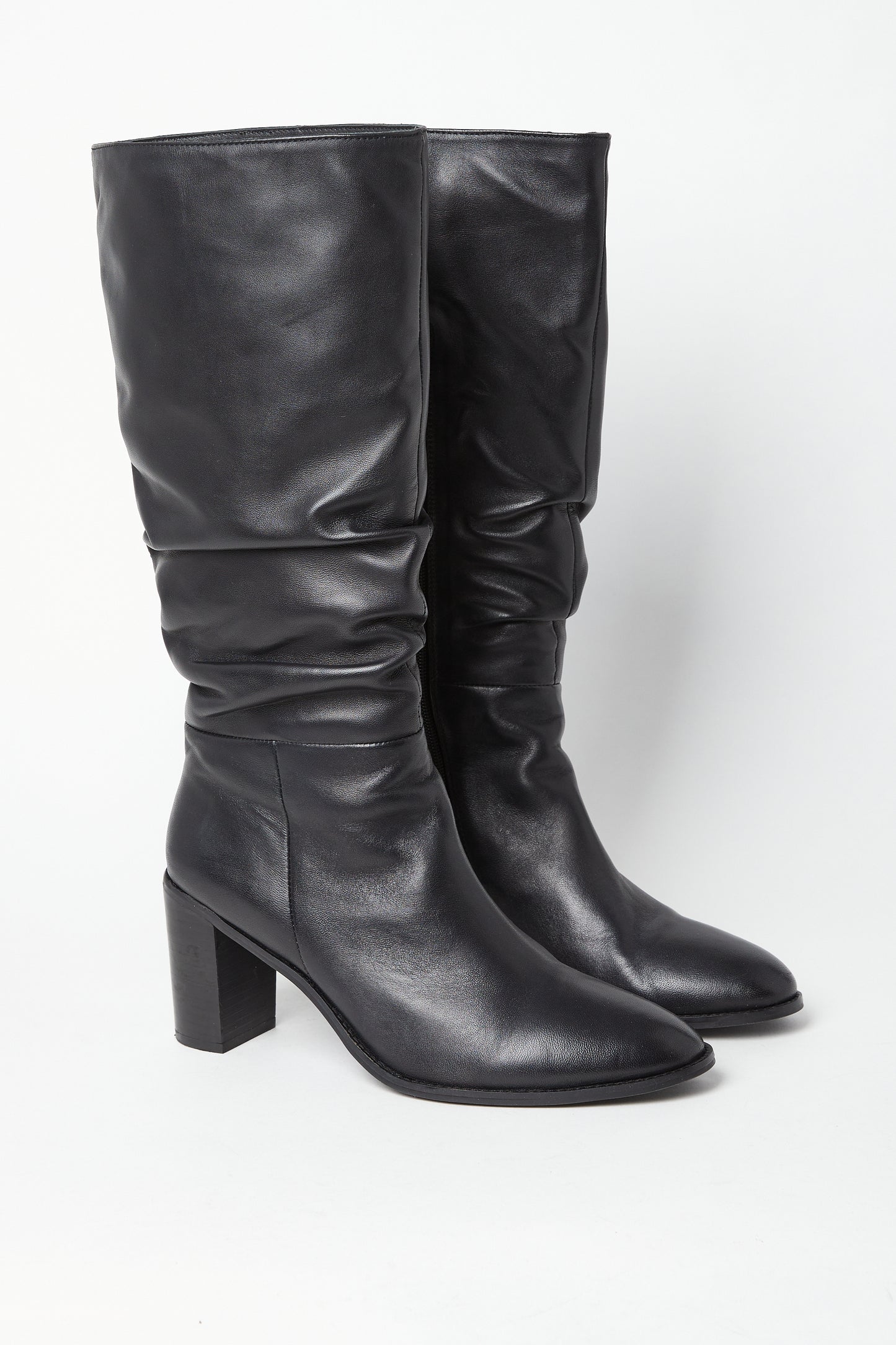 Edit No9. A pair of black leather ruched knee boots with a round-toed silhouette and a high block heel. Large sizes.
