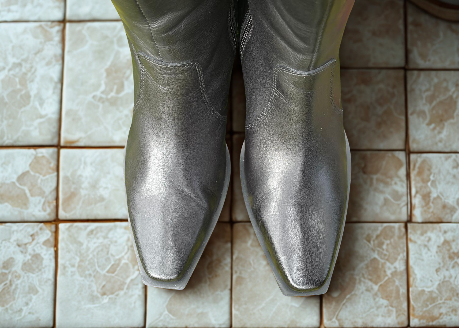 Black boots on tilled floor